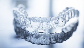 Invisalign braces lying on highly reflective table